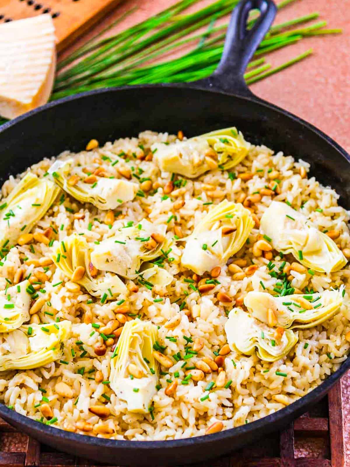 Cast iron pan filled with parmesan artichoke risotto.