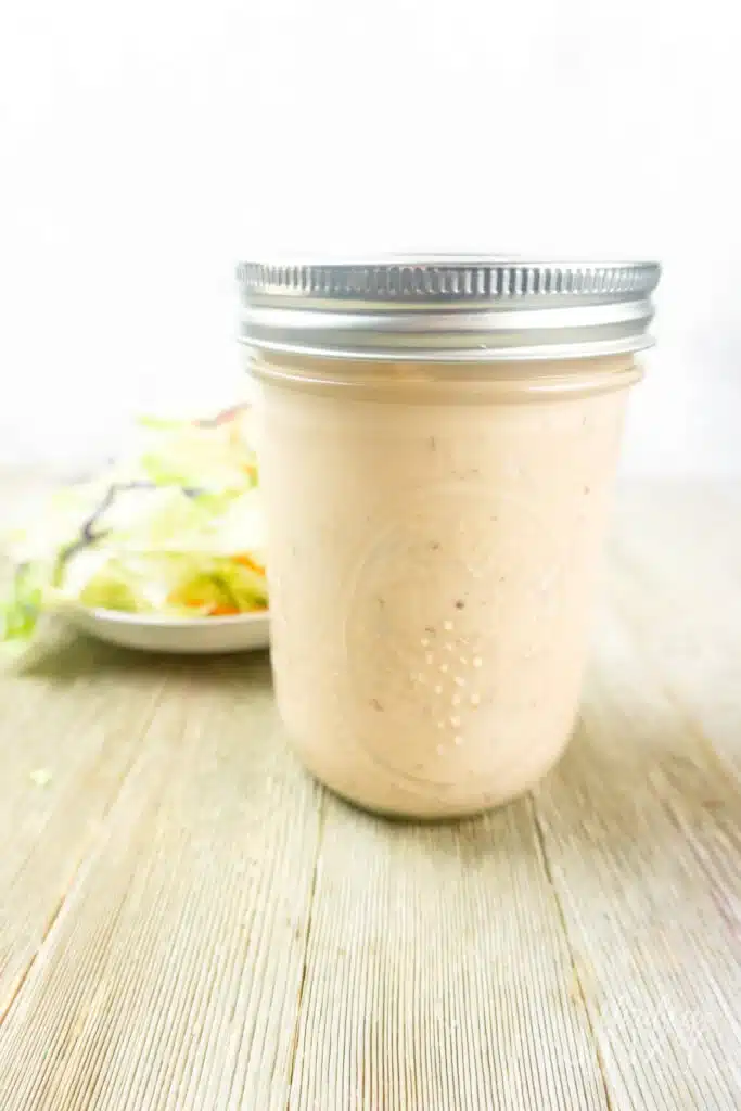 Mason jar full of thousand island dressing.