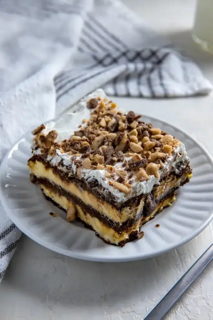 Slice of ice cream sandwich cake on a white saucer.