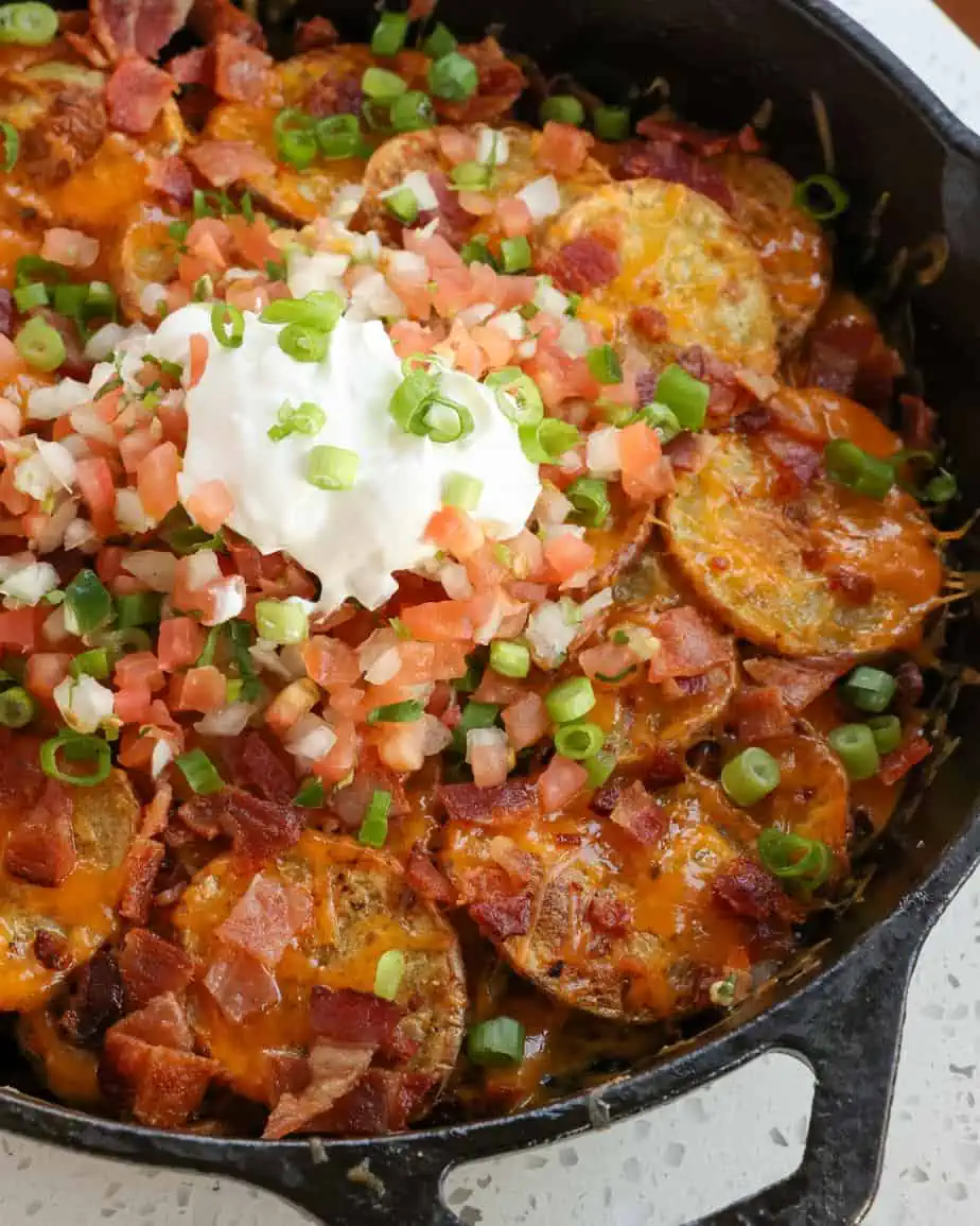 Close up of cast iron pan full of Irish nachos.