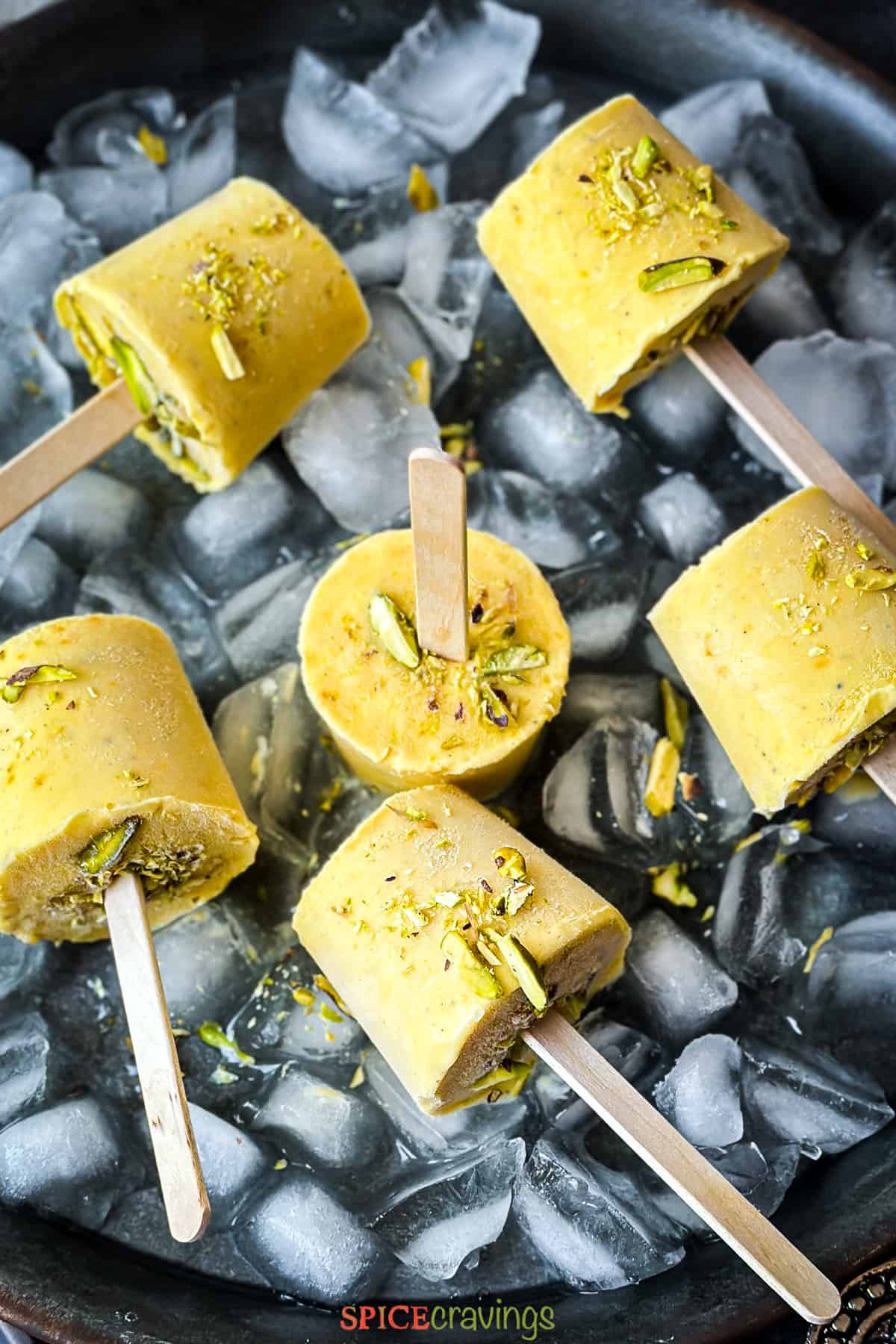 Mango kulfi popsicles on ice.