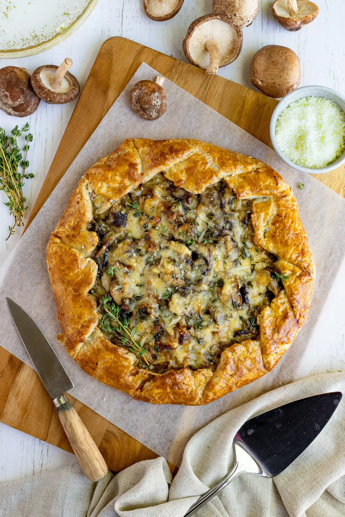 Mushroom galette with mushrooms in the background.