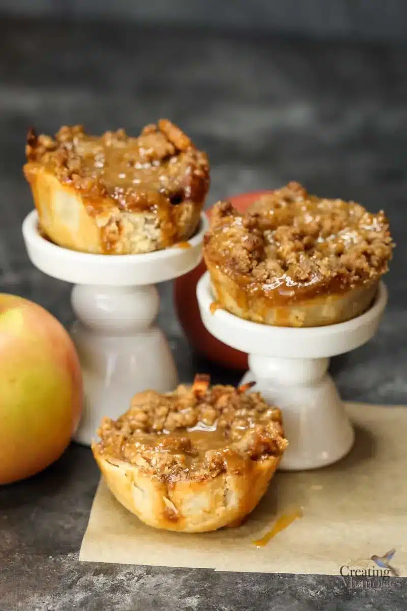 Caramel apple bites on white stands.