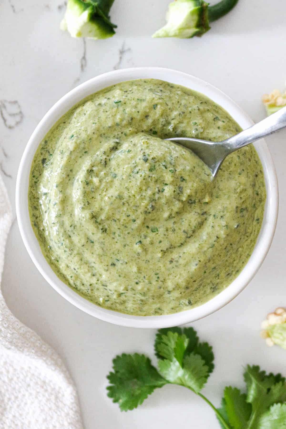 Poblano sauce with spoon in a bowl.