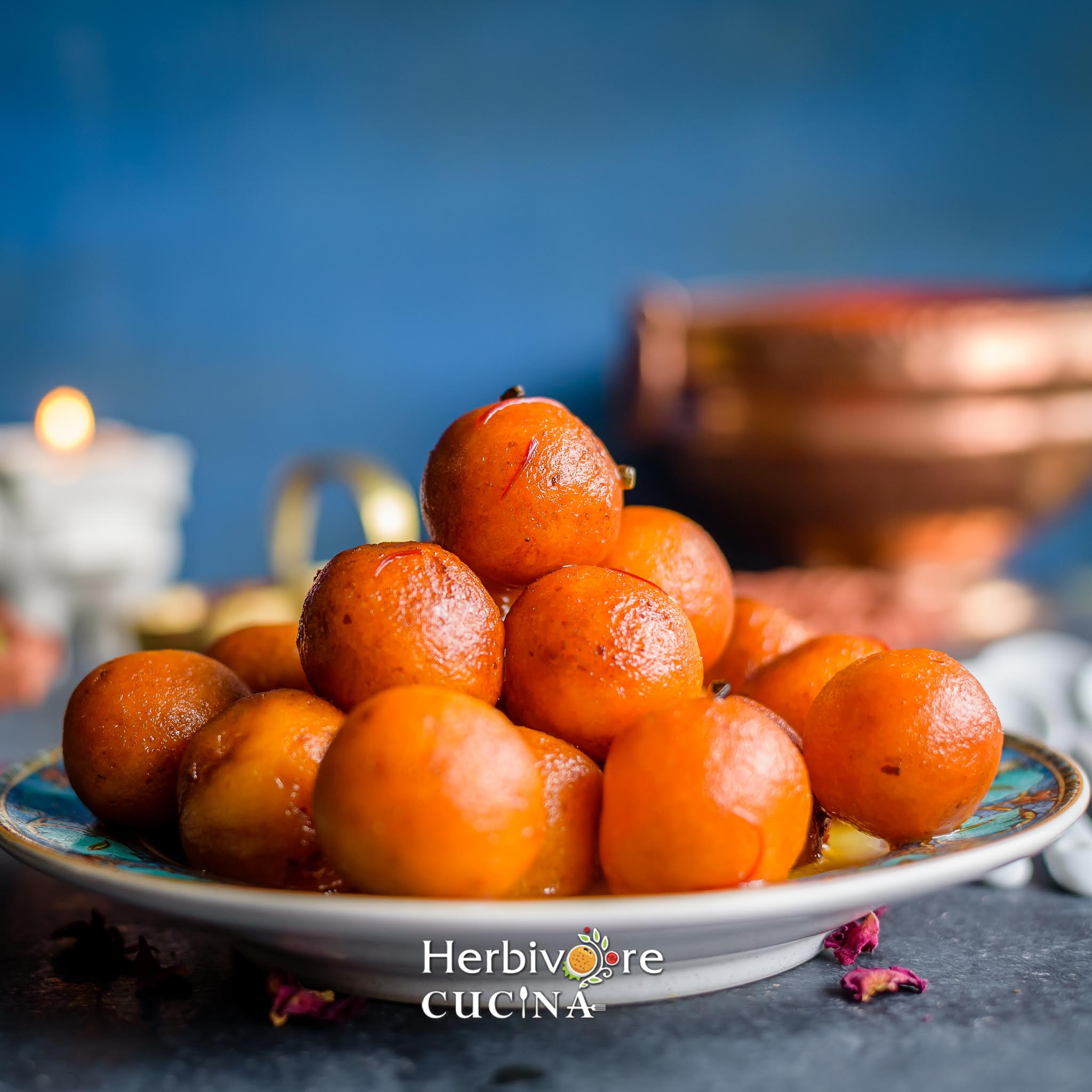 Plate full of ricotta cheese Gulan Jamun dessert.