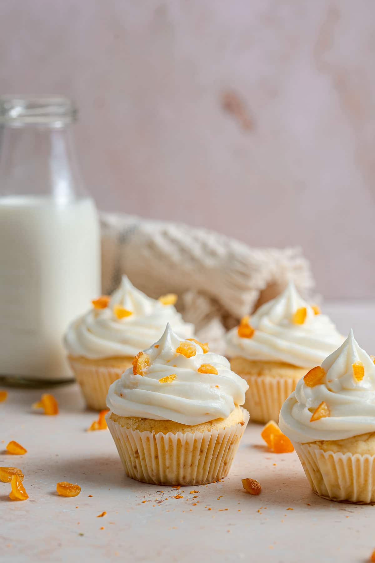 Pound cake cupcakes with ricotta frosting on a light surface.