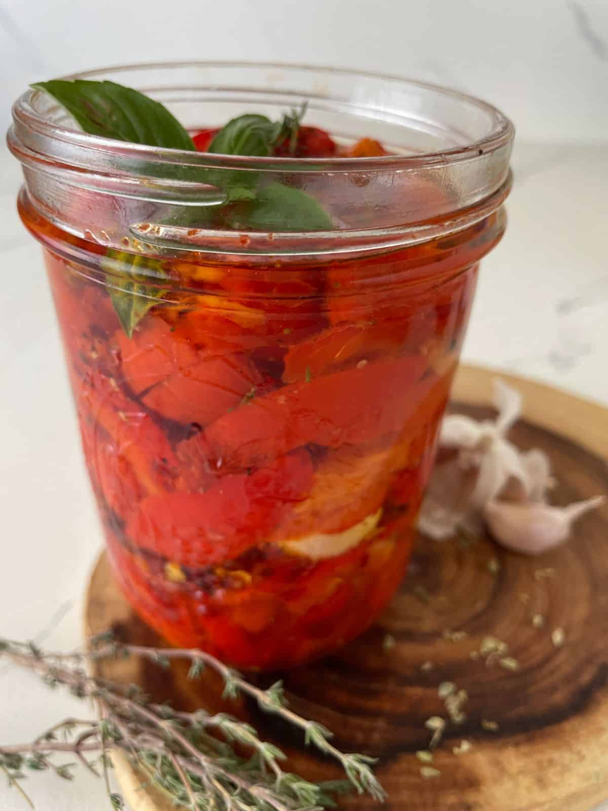 Jar full of herbed roasted red peppers.