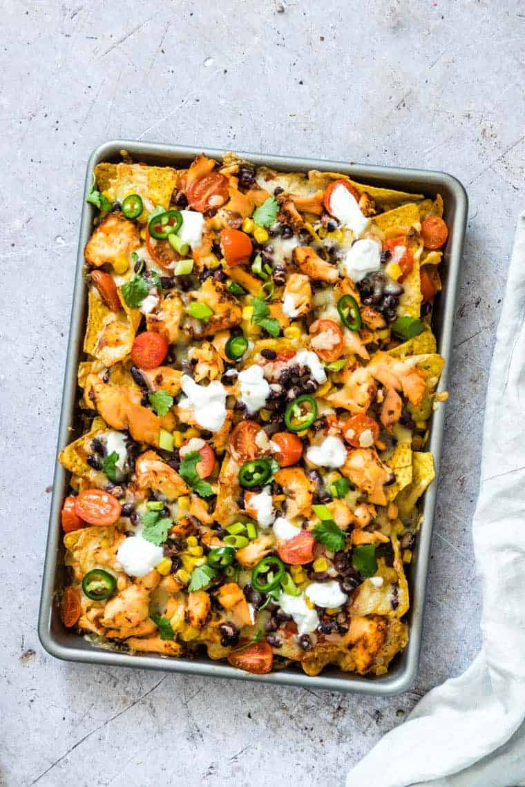 Sheet pan full of salmon black bean nachos.