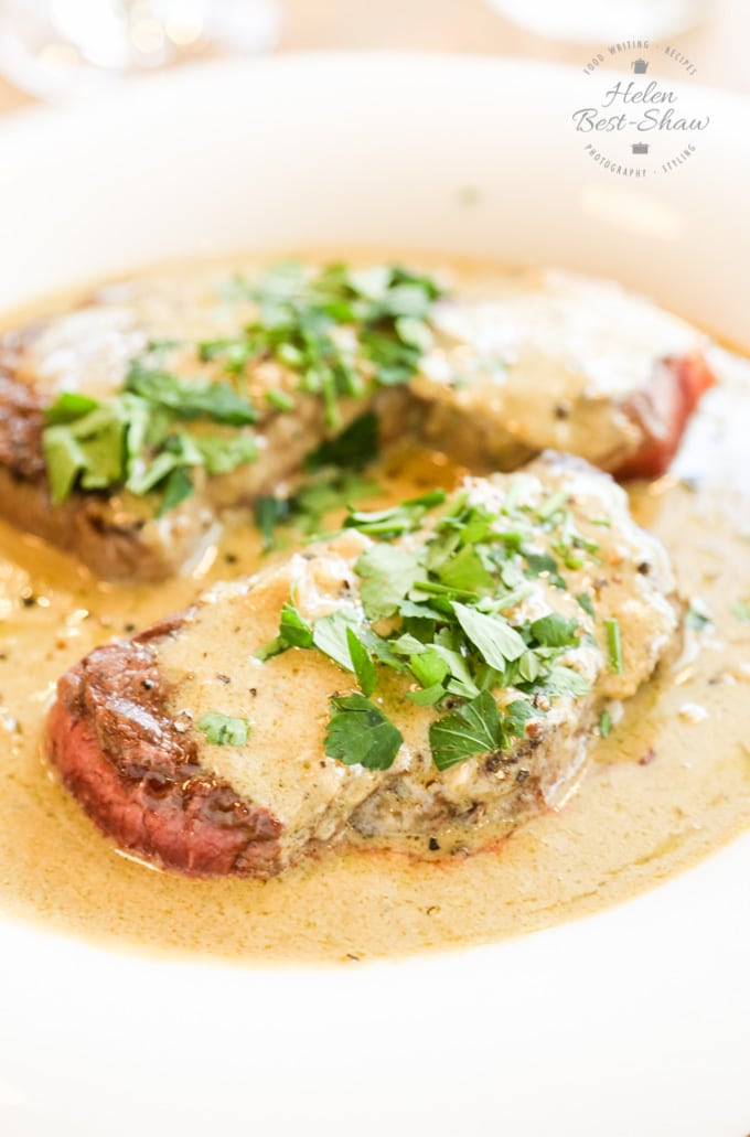 Steak covered with stilton sauce and herbs.