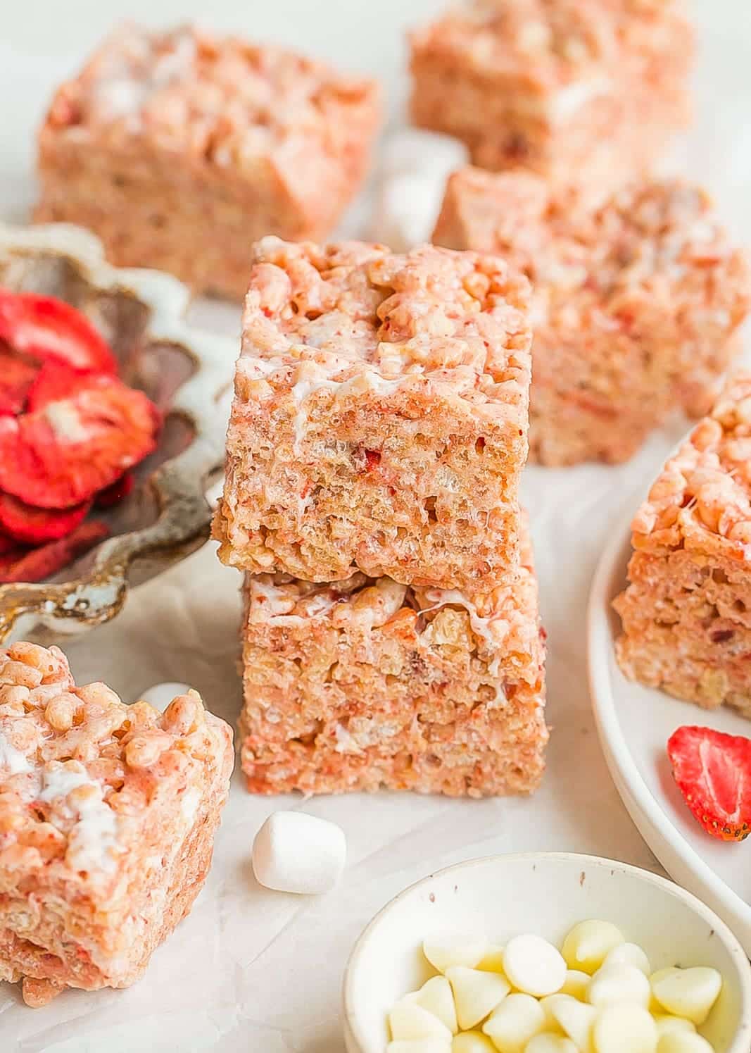 Slices of strawberry rice crispy treats stacked on each other.