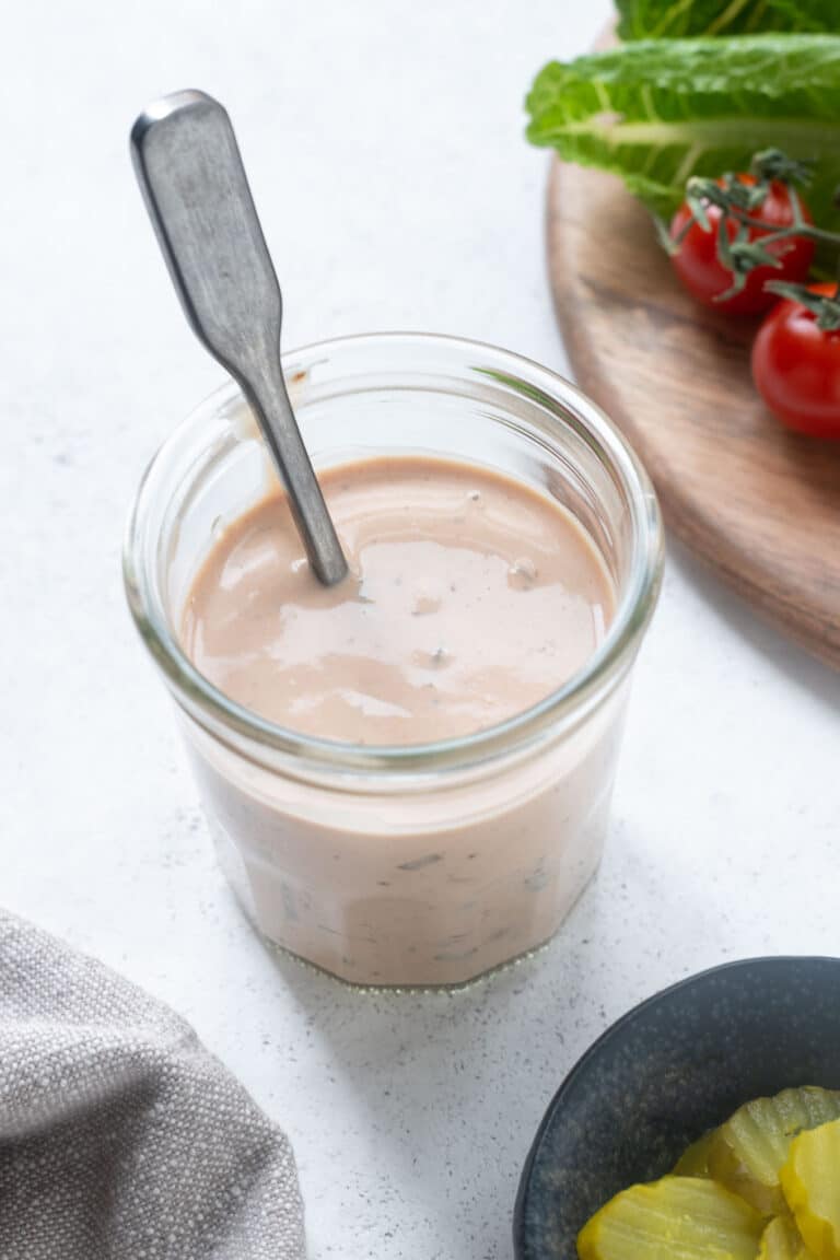 Burger sauce with spoon in a mason jar.