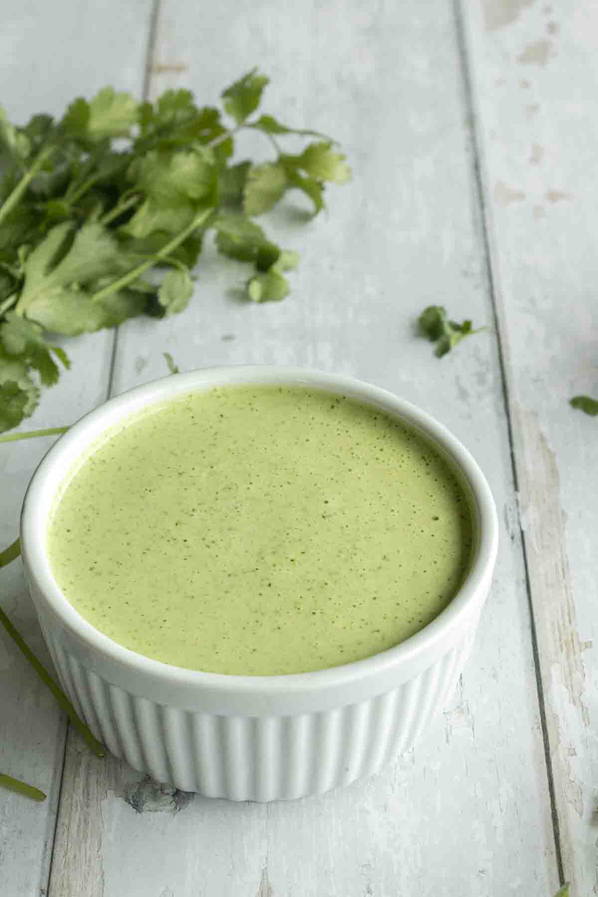 Cilantro lime crema sauce in a ramekin.