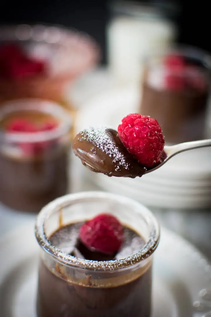 Spoon with pudding and raspberry.