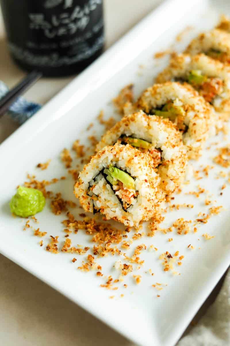 California sushi roll, sliced on a square plate.