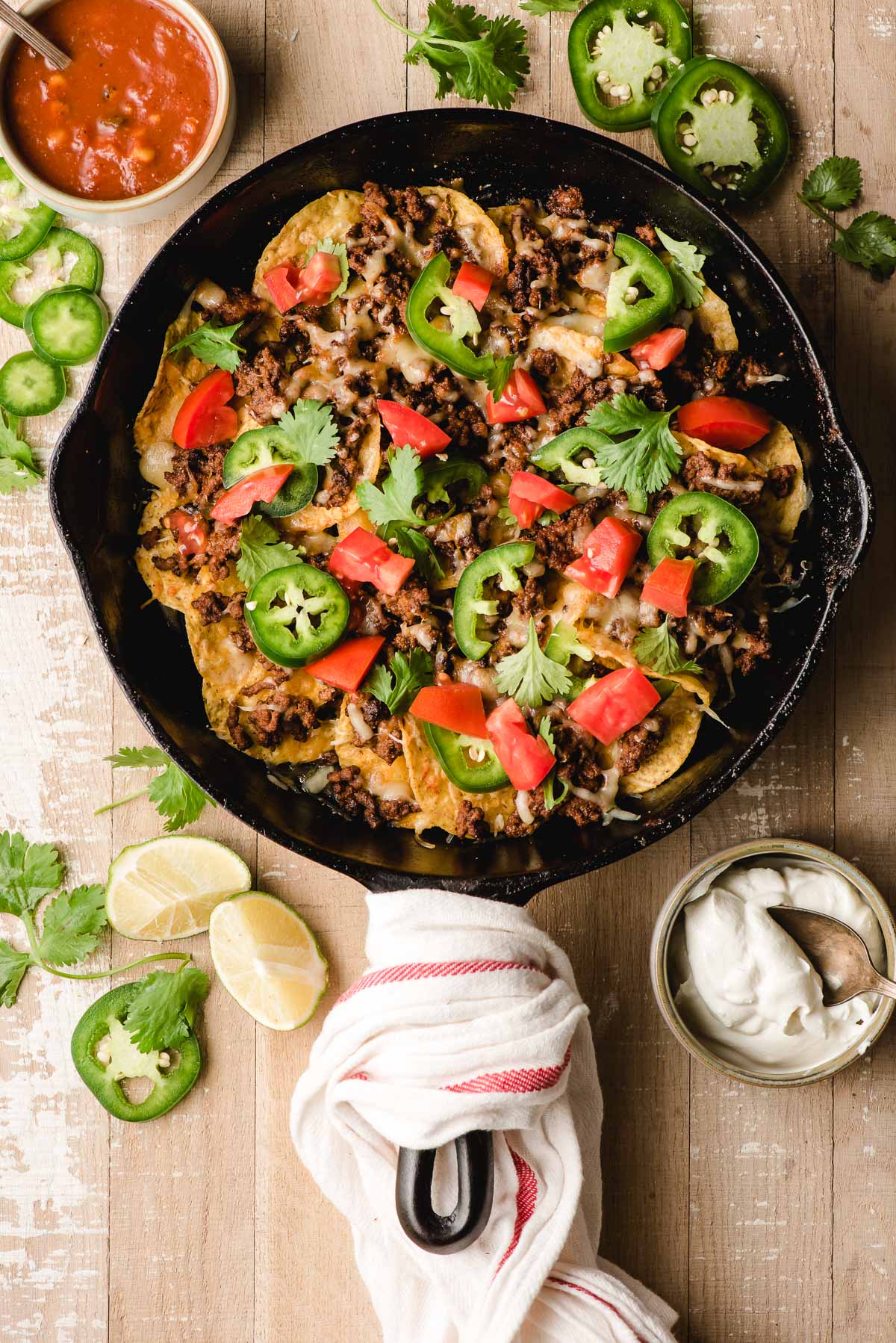 Ground beef nachos in a cast iron pan.