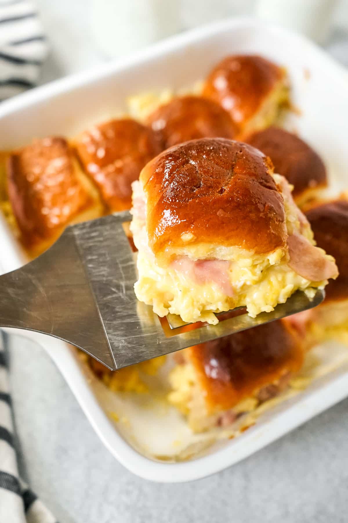 Hawaiian roll breakfast sliders in a baking dish.