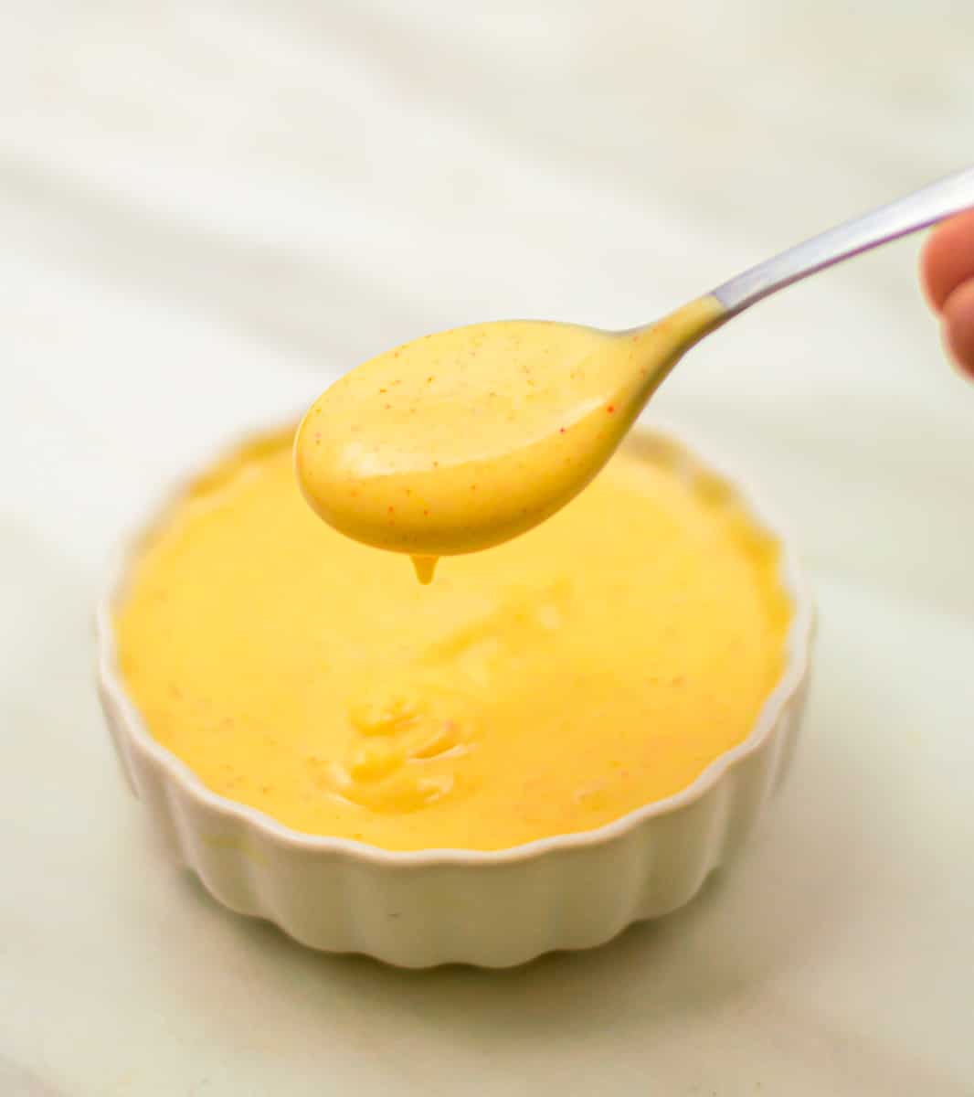 Spoon full of honey mustard sauce.