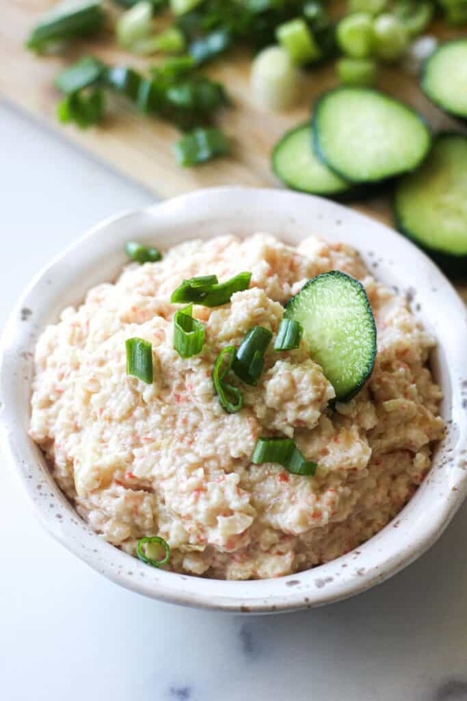 Crab dip with sliced cucumber.