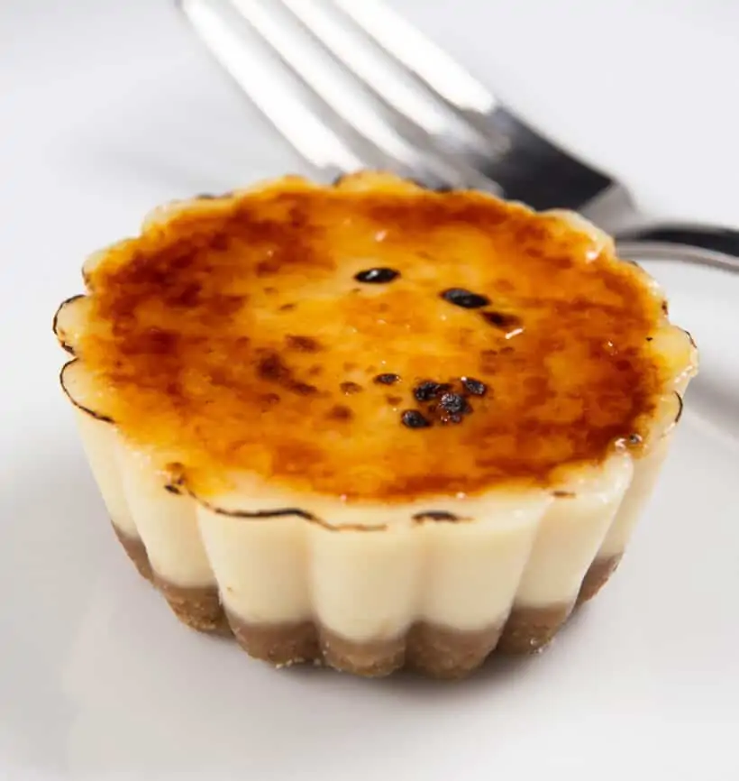 Cheesecake creme brulee bites with a fork in the background.