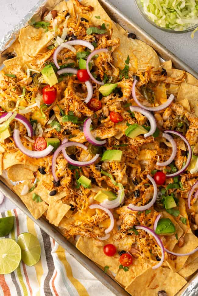 Sheet pan full of Mexican chicken sheet pan nachos.