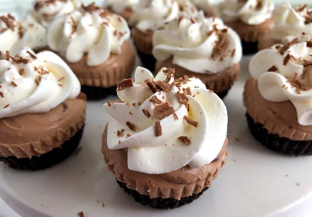 Bailey's mini cheesecakes on a white plate.