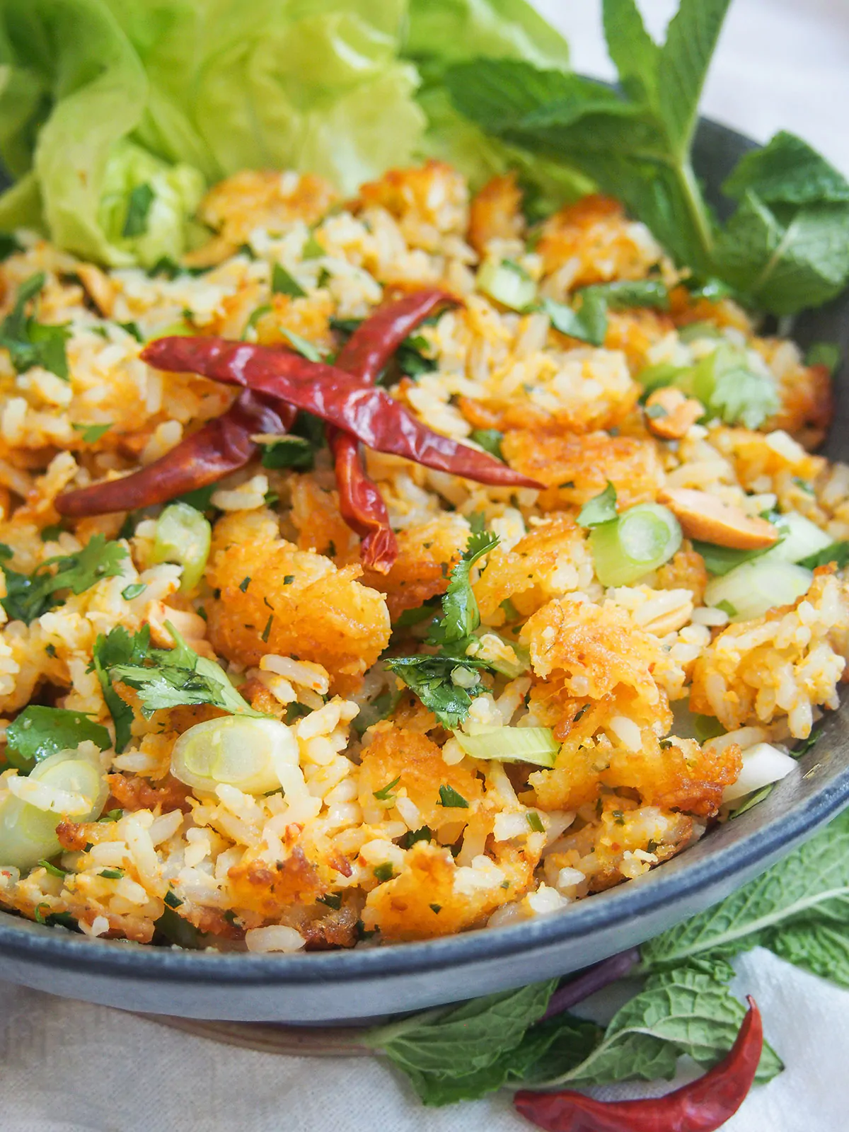 Crispy rice salad with herbs and whole red chilies.