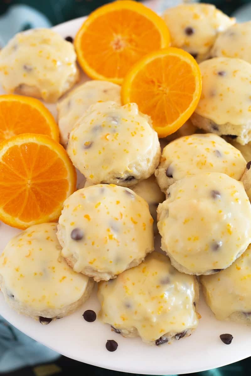 Orange ricotta and chocolate chip cookies and orange slices.