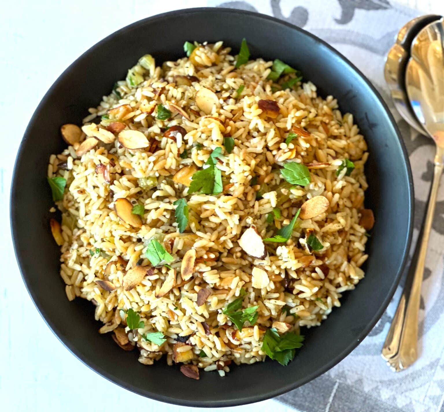 Rice pilaf in a black bowl.