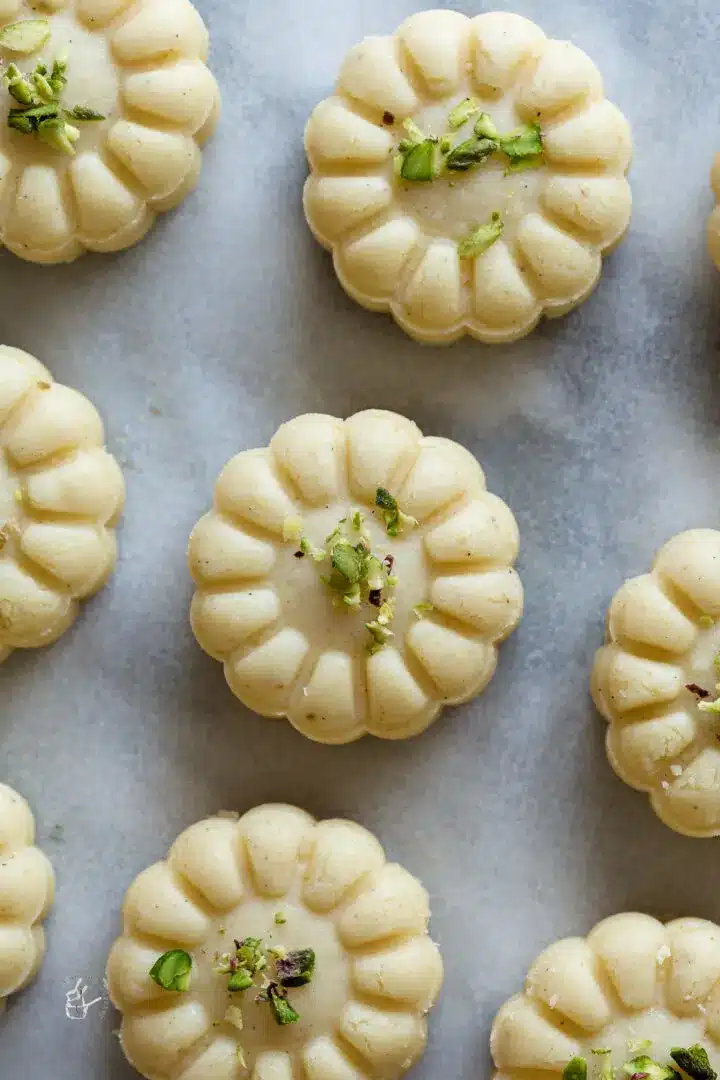 Decorative ricotta cheese peda with pistachio garnish.