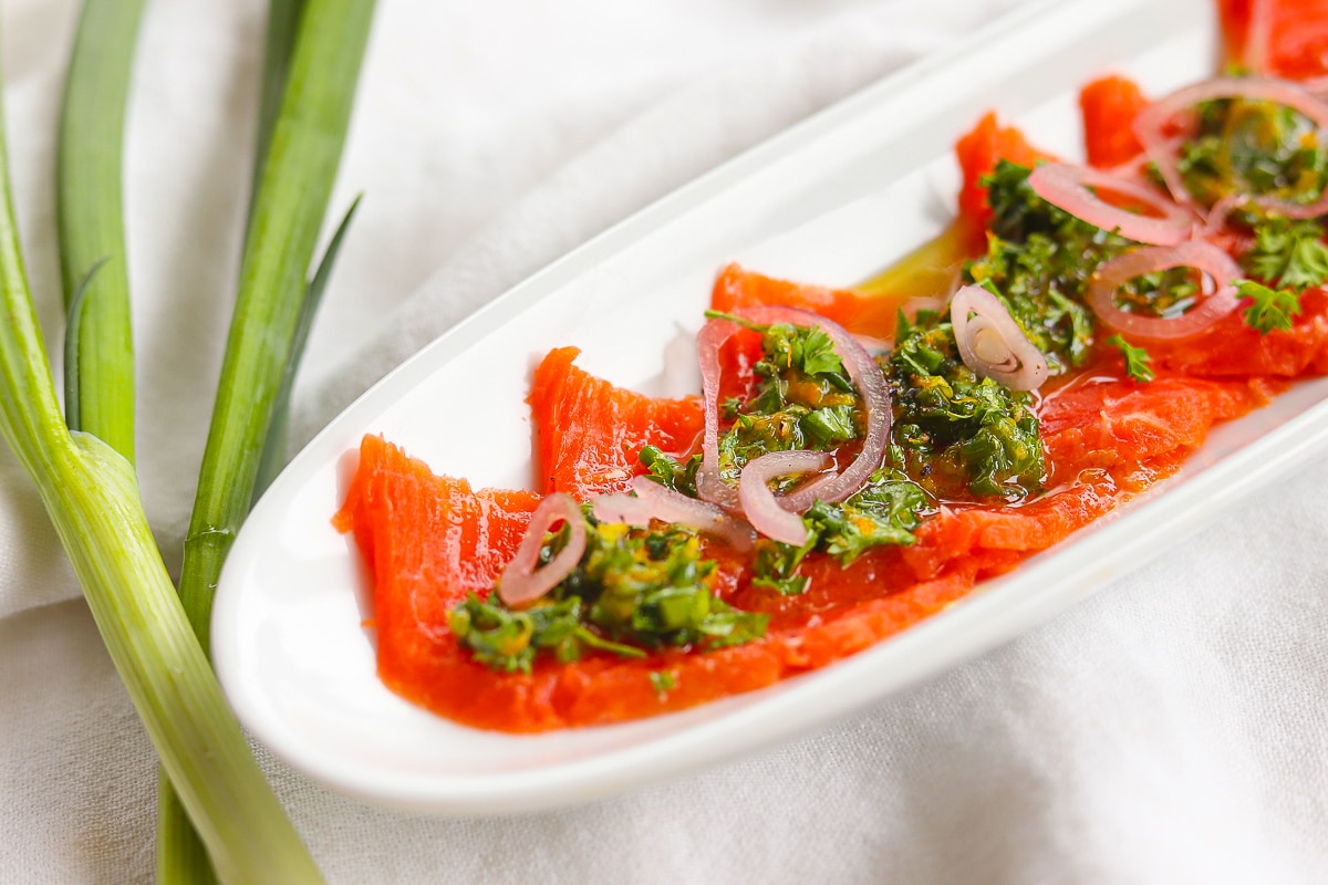 Salmon crudo on a platter.