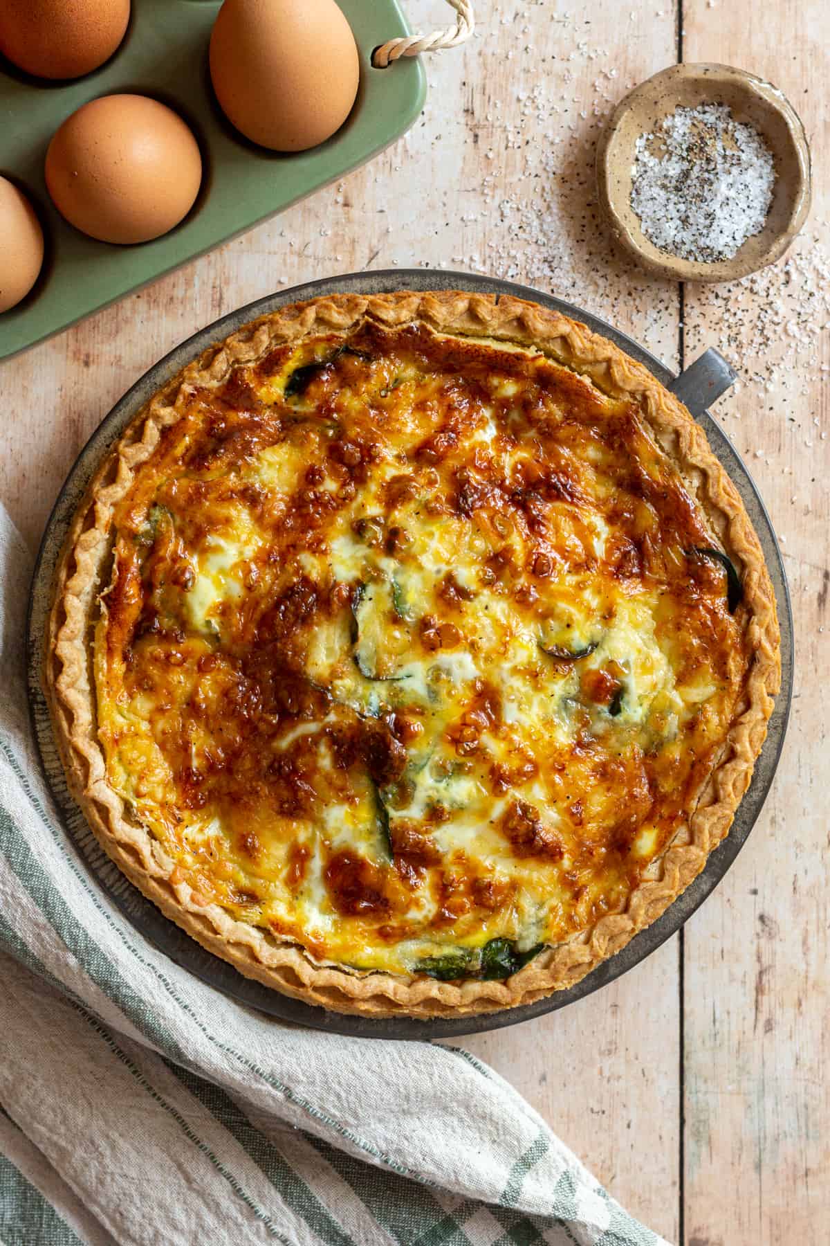 Sausage and spinach quiche with eggs, salt, and pepper.