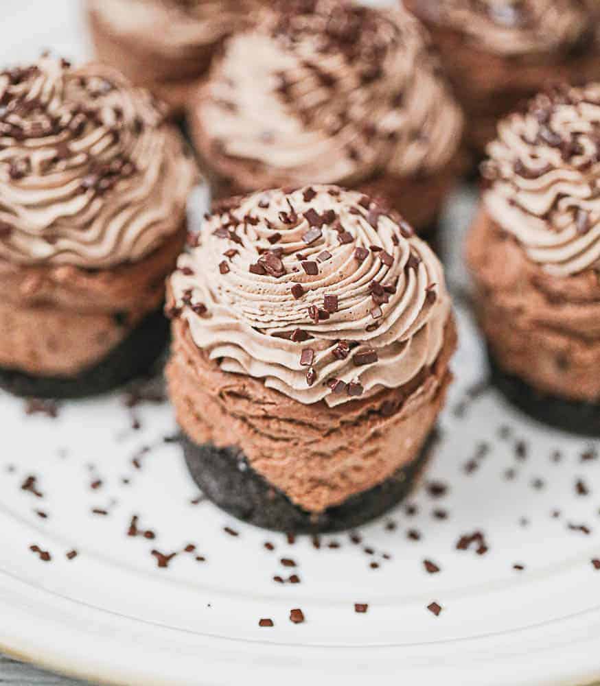 Triple chocolate cheesecake on a white plate.