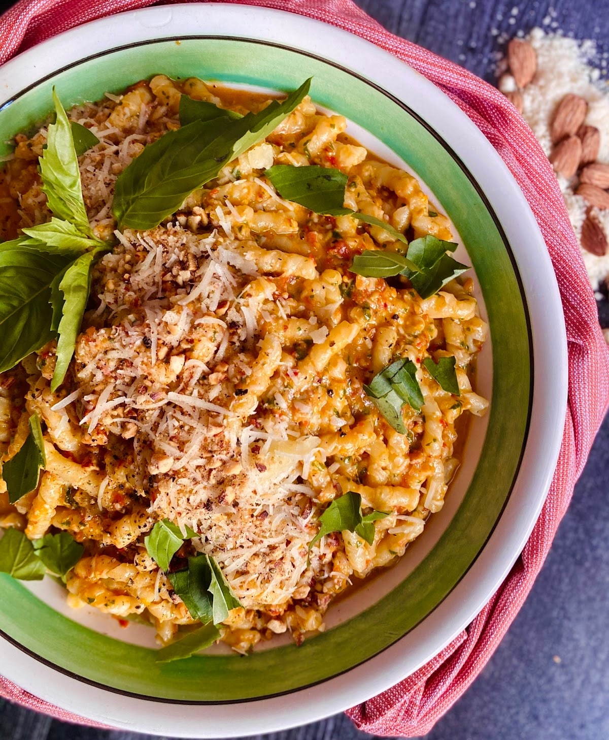 Colorful pasta recipe in a green bowl.