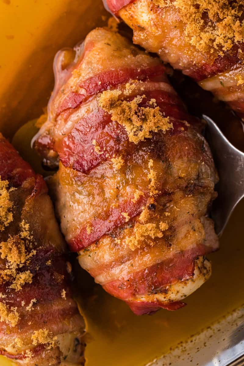 Up close of a bacon wrapped chicken breast.