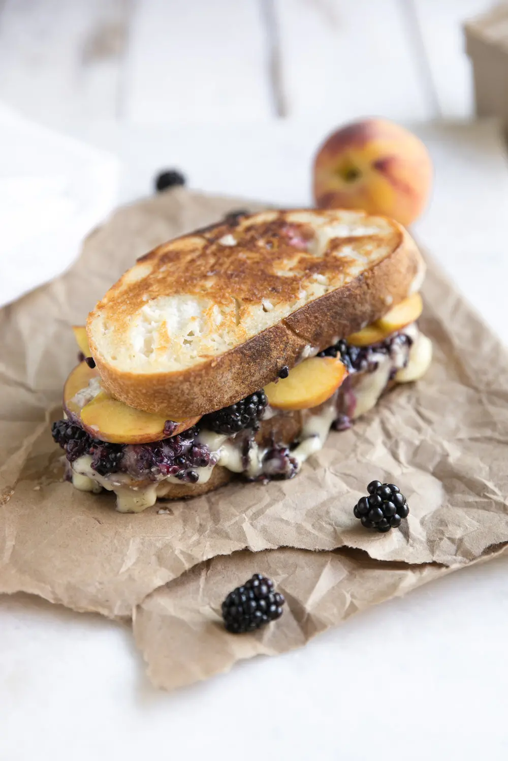 Grilled cheese sandwich with peaches and blackberries.