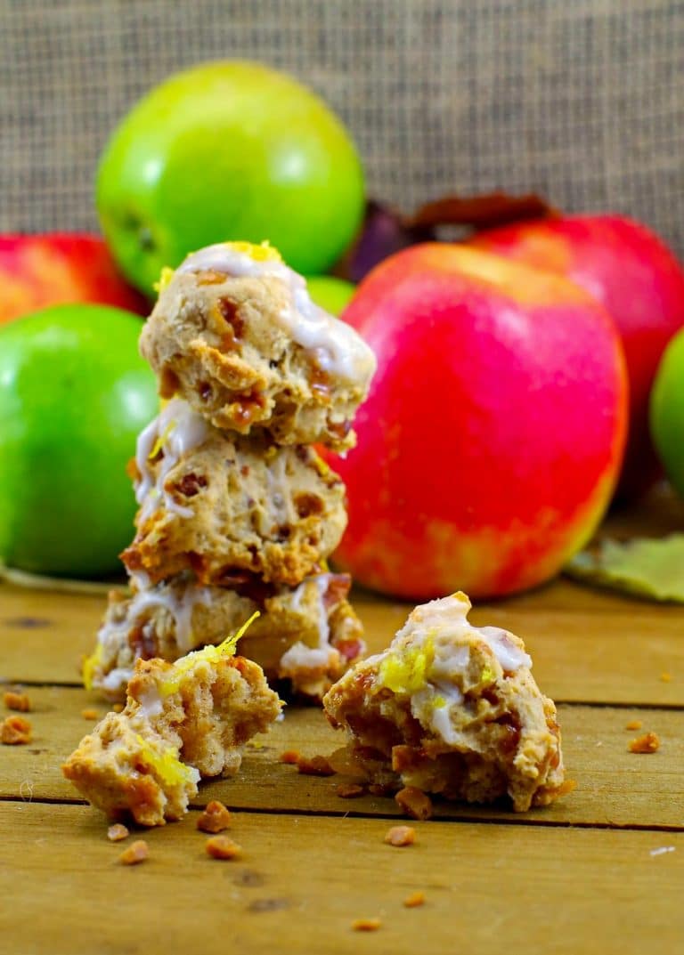 Stack of toffee apple pie cookies with red and green apples in the background.