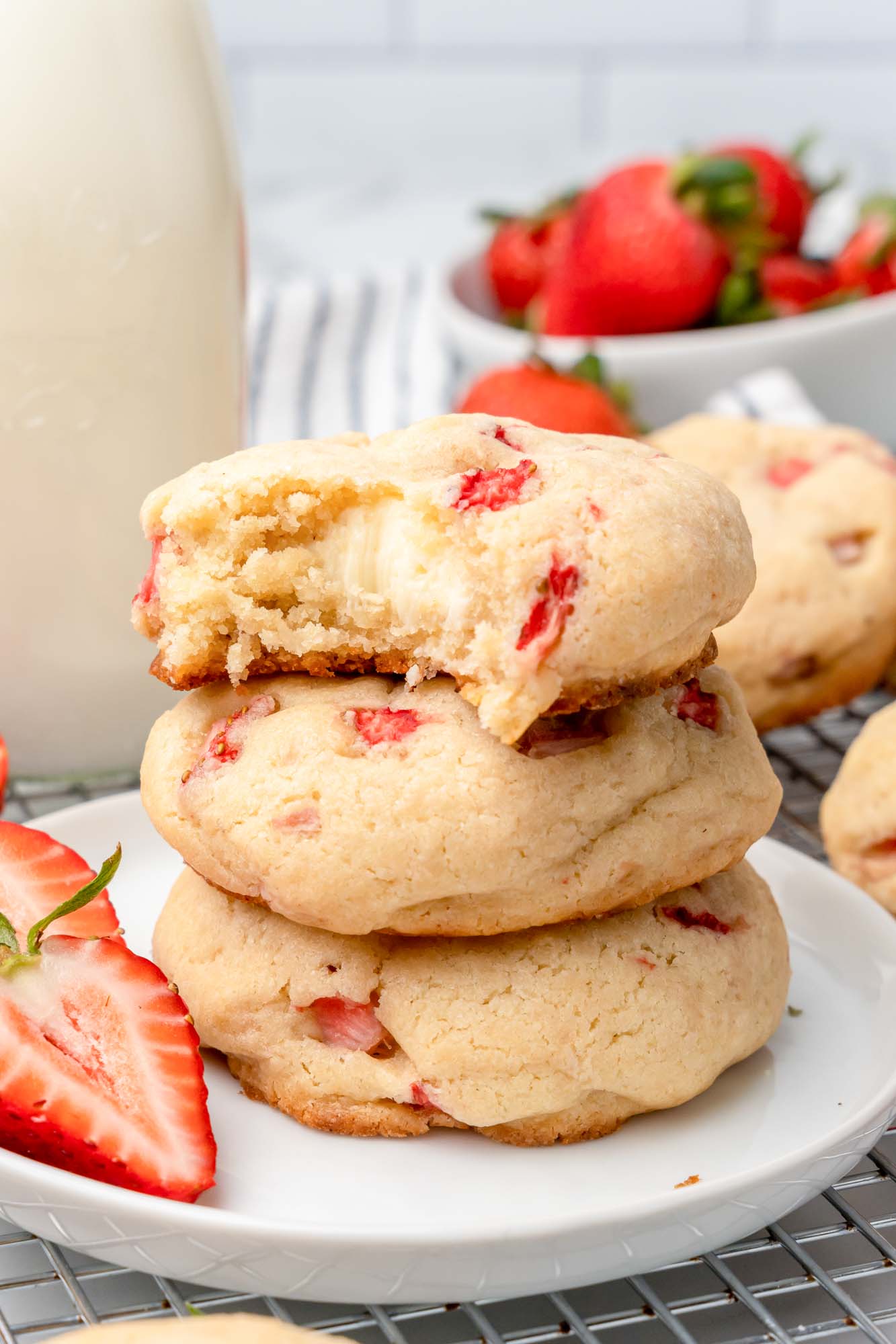 Stack of strawberry cheesecake cookies on a white plate.