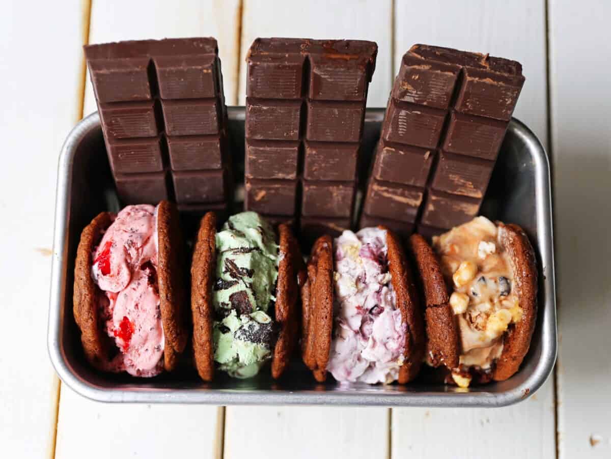 Chocolate cookie ice cream sandwiches in a silver box.