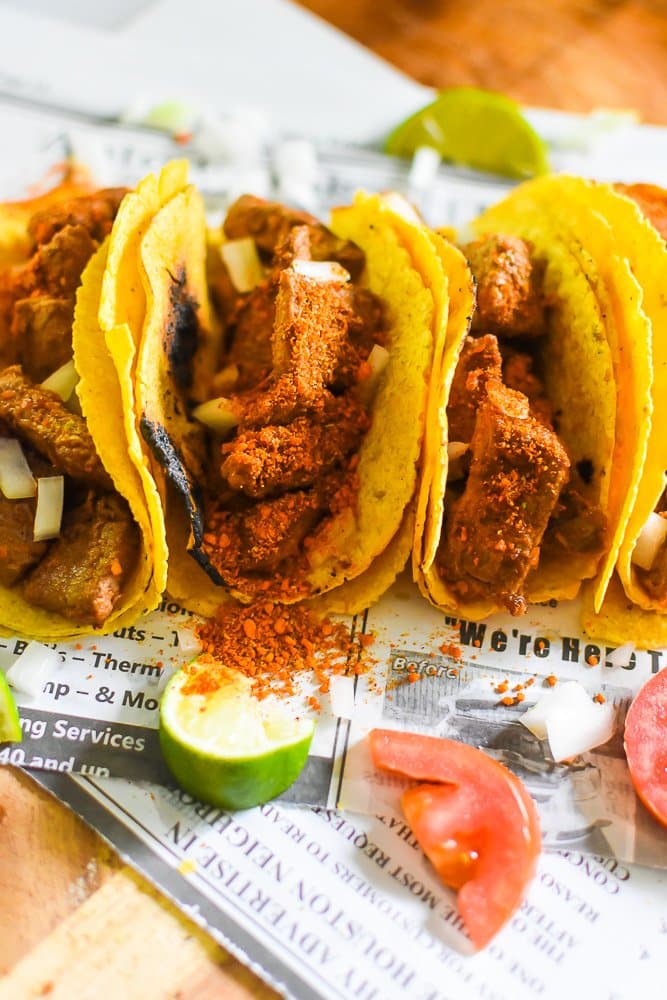 Suy street tacos on newspaper.