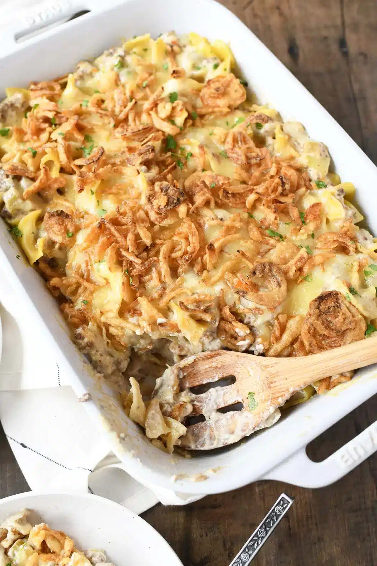 French onion ground beef casserole in a white baking dish.