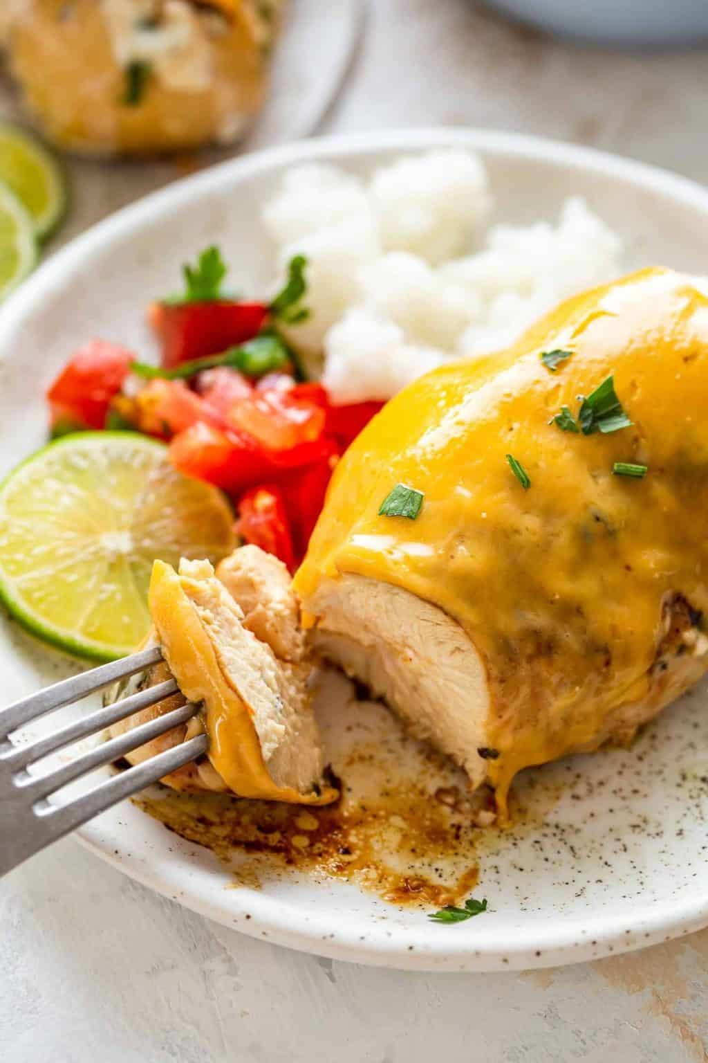 Fiesta lime chicken on a white speckled plate with a fork.