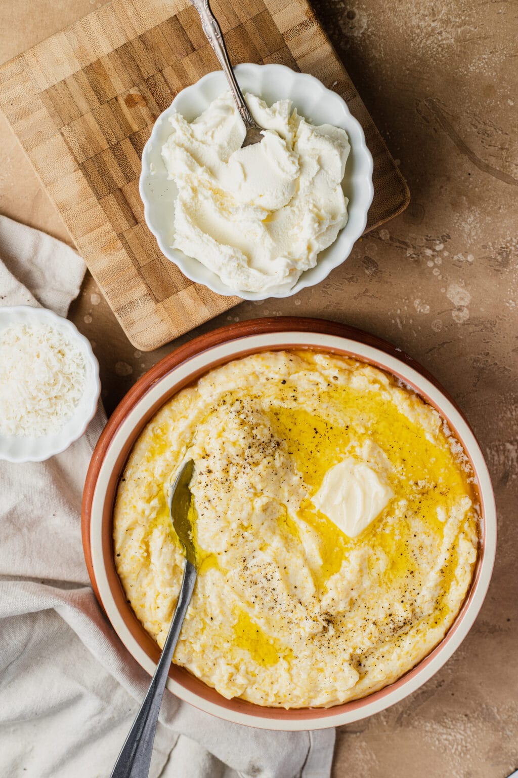 Mascarpone polenta in a bowl with a spoon.