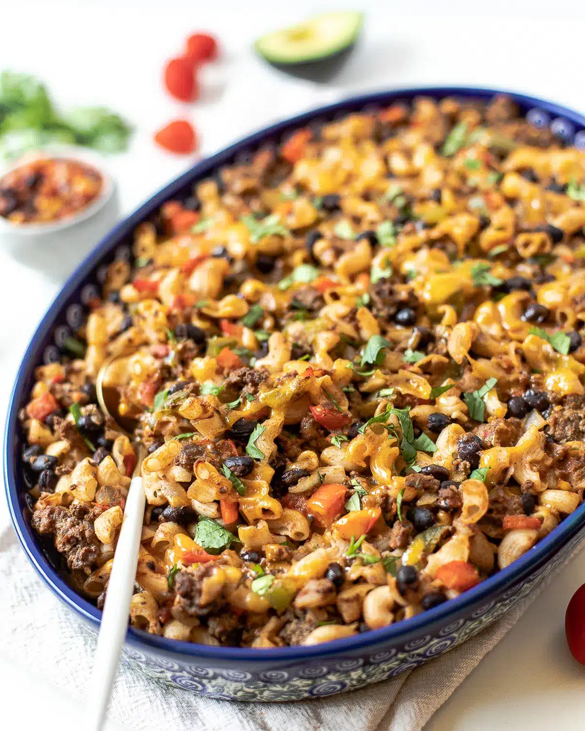 Mexican pasta bake in a blue baking dish.