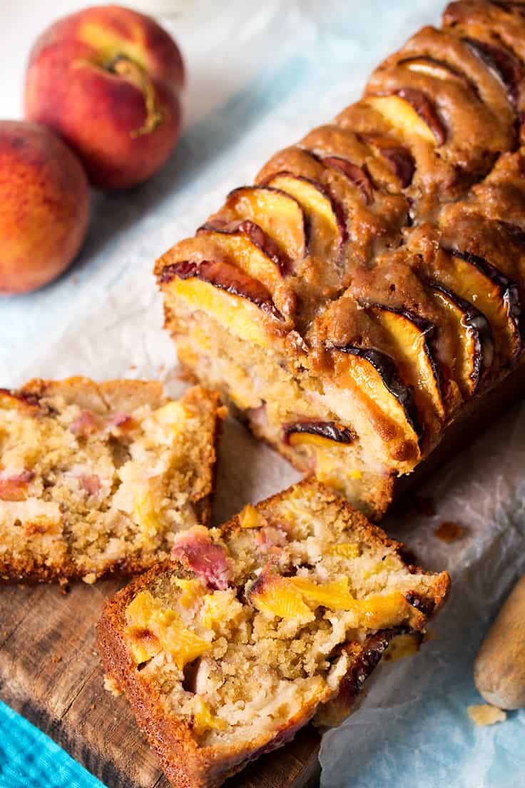 Peach bread with slices on a cutting board.