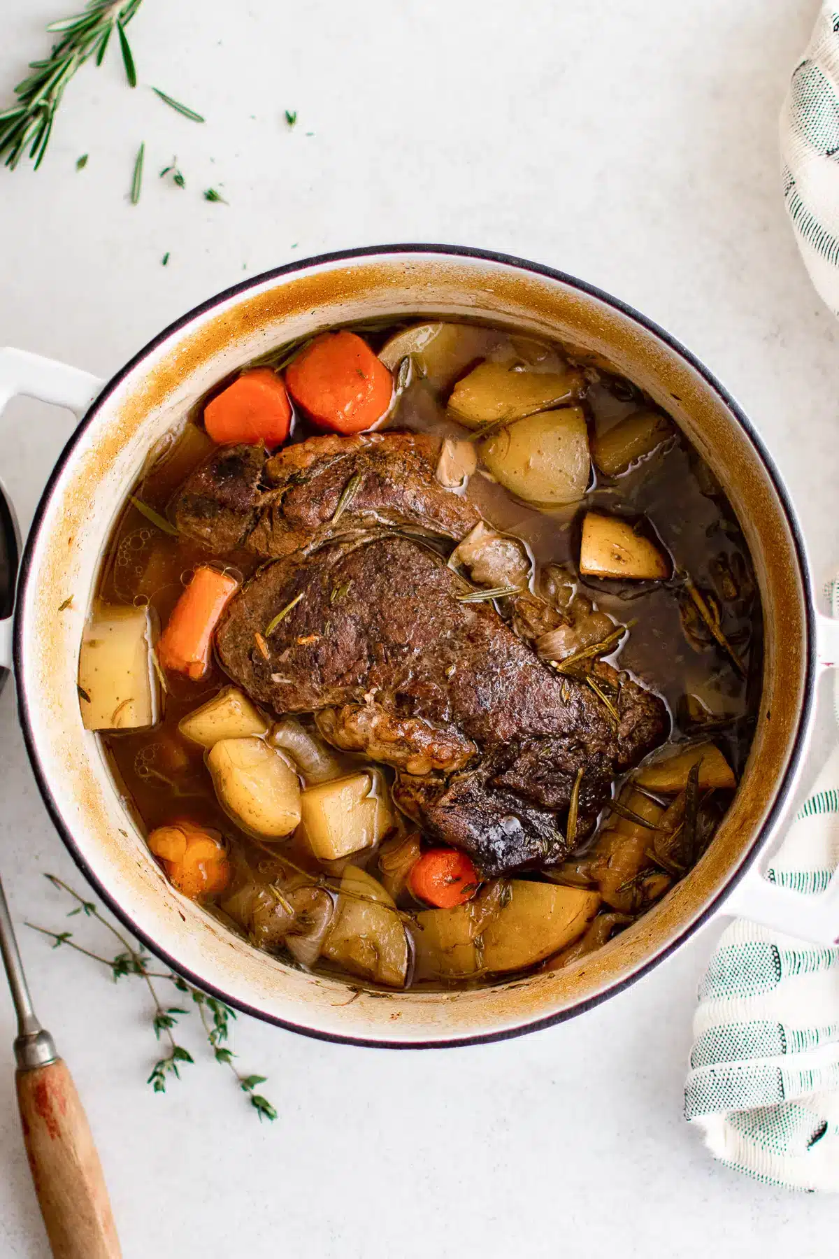 Pot roast with potatoes and carrots in a Dutch oven.