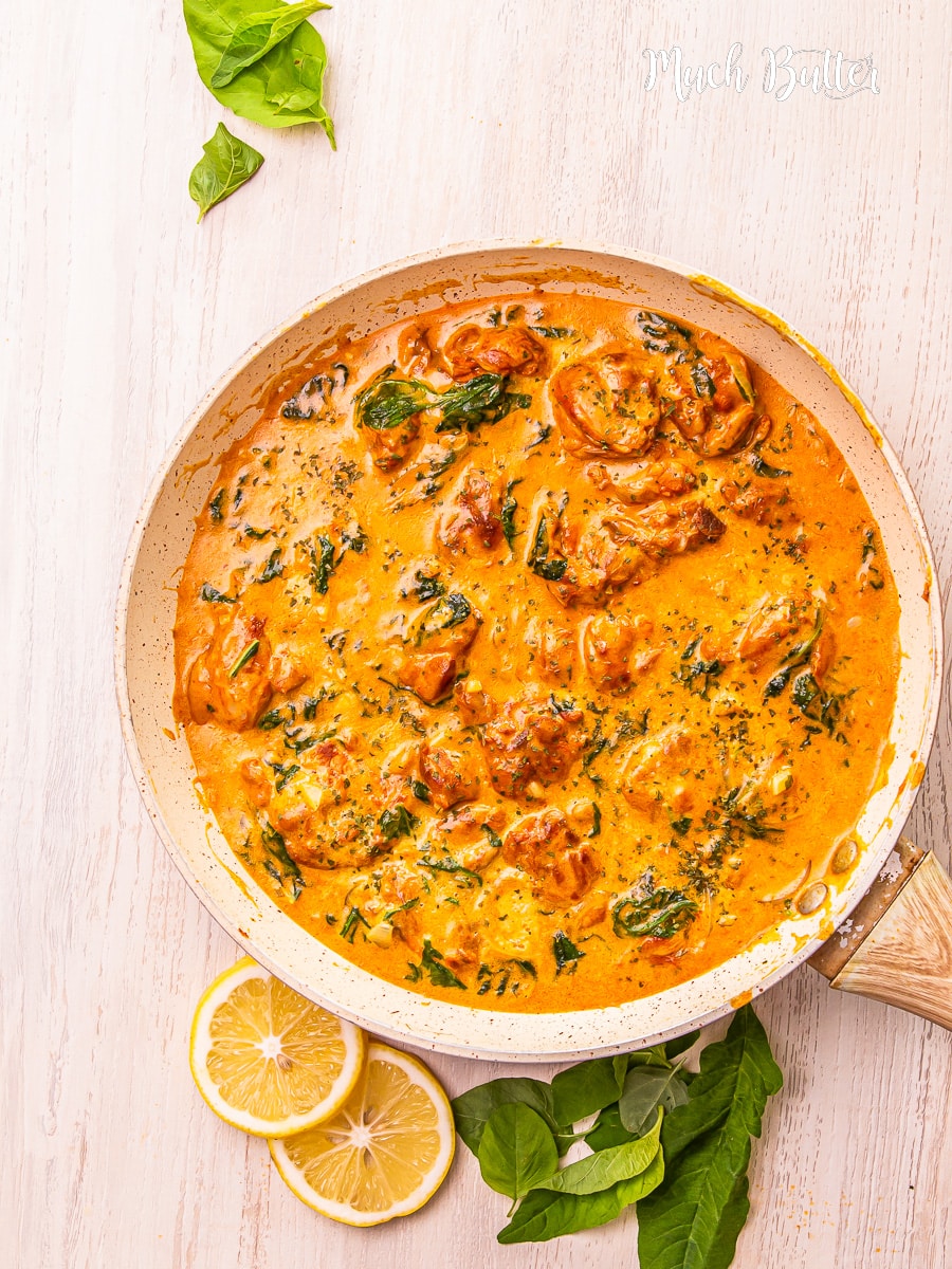 Overhead shot of creamy spinach chicken thighs in a skillet.