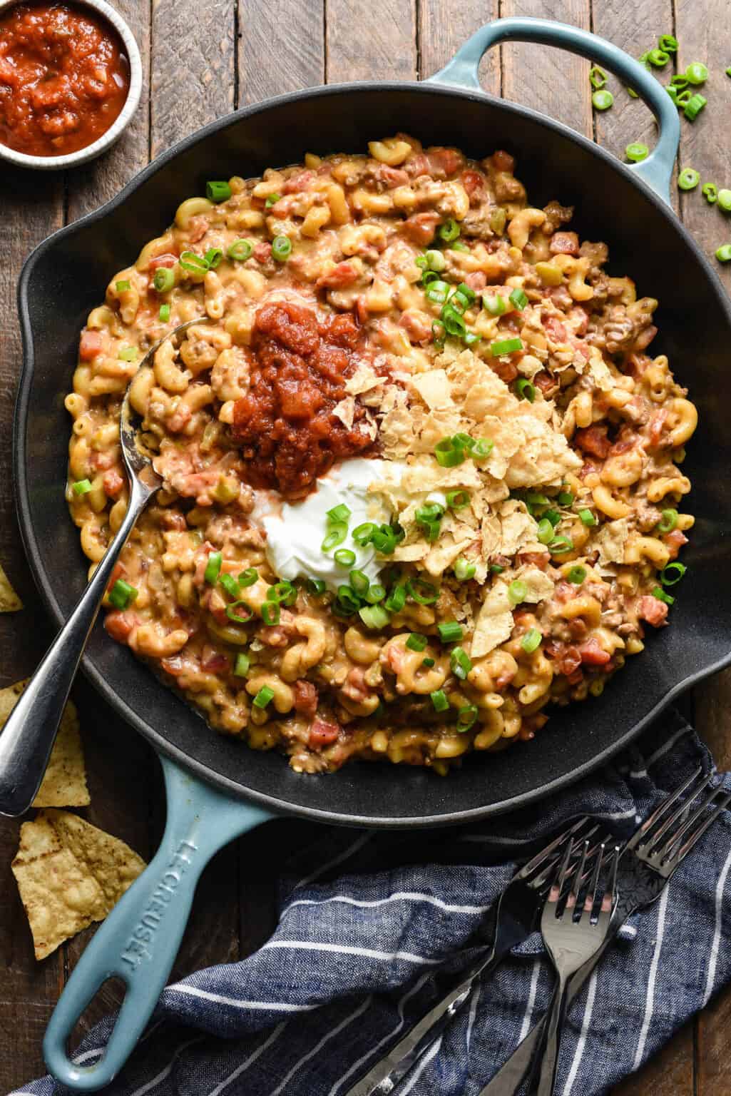 Taco mac and cheese in a skillet with forks.