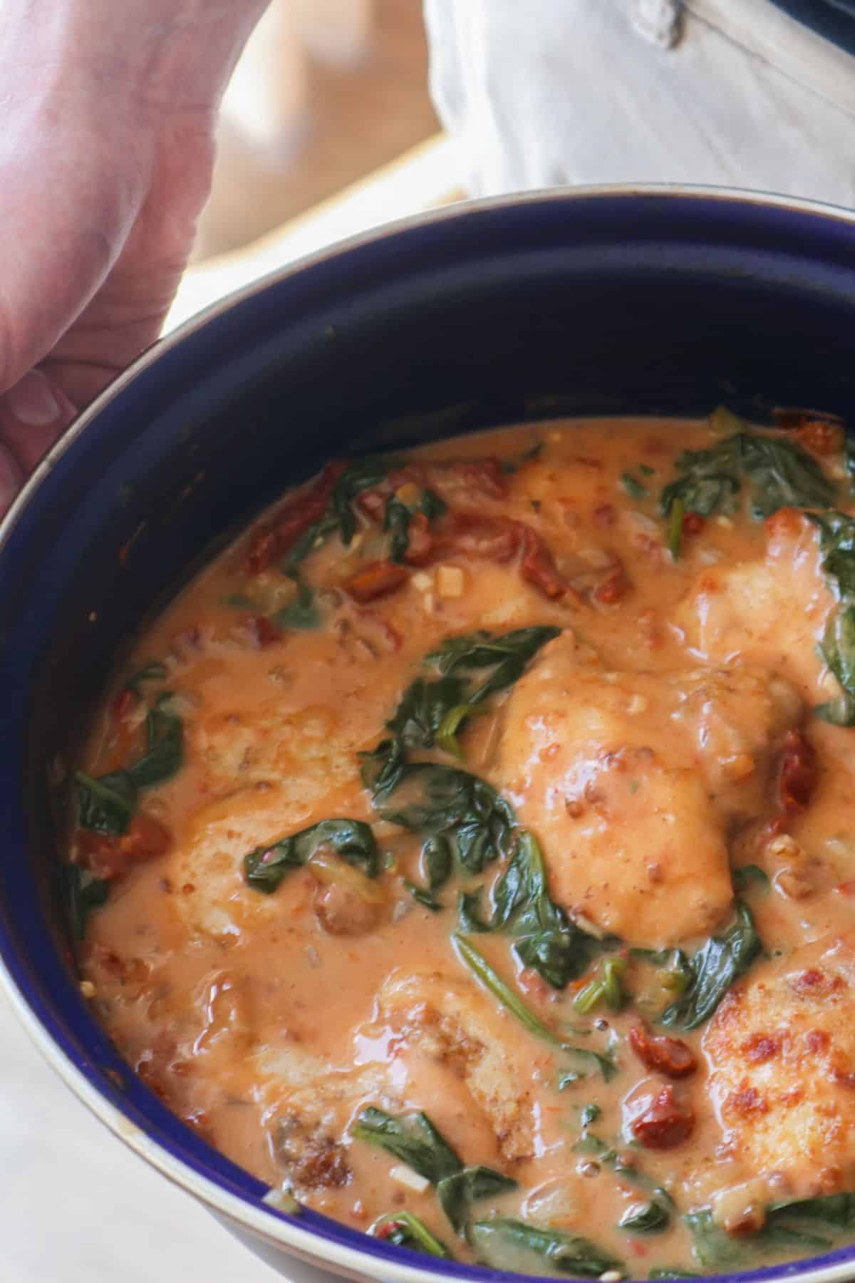 Crockpot full of creamy Tuscan chicken.