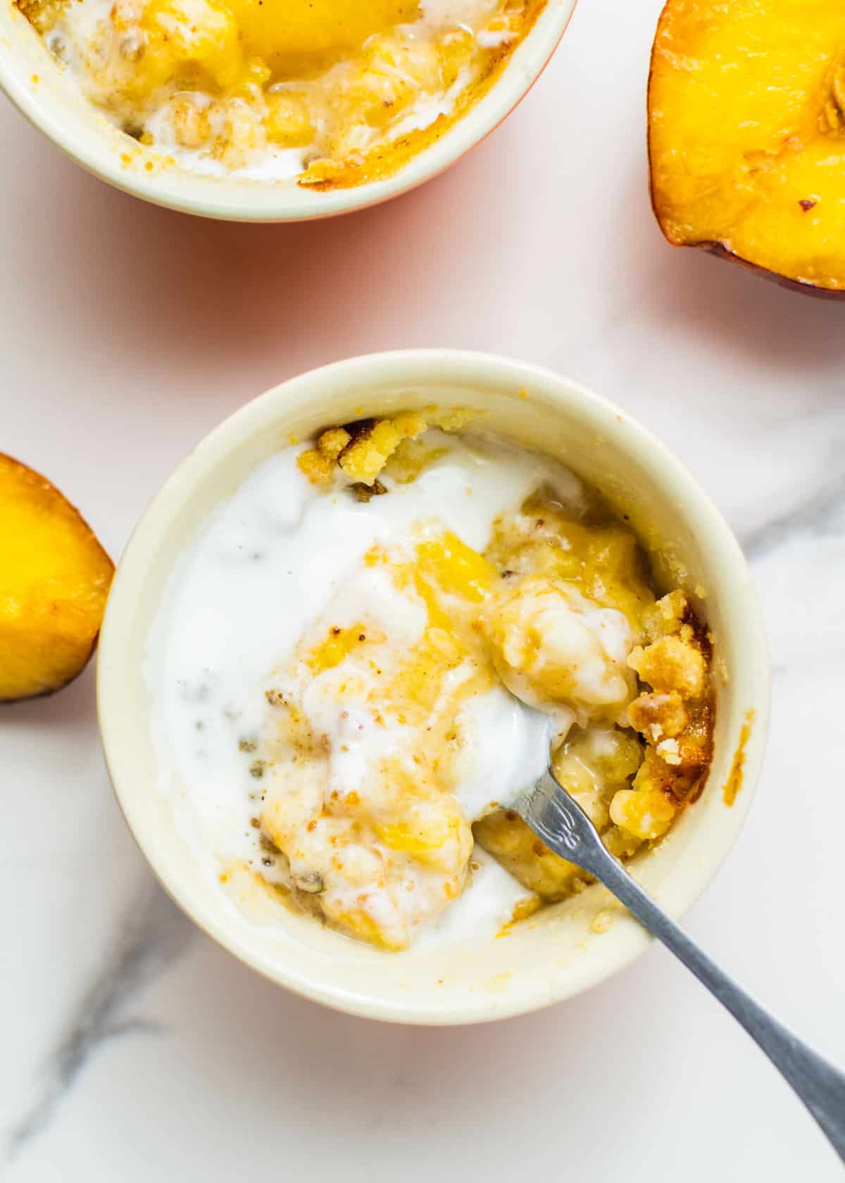 Air fryer peach cobbler in a white bowl