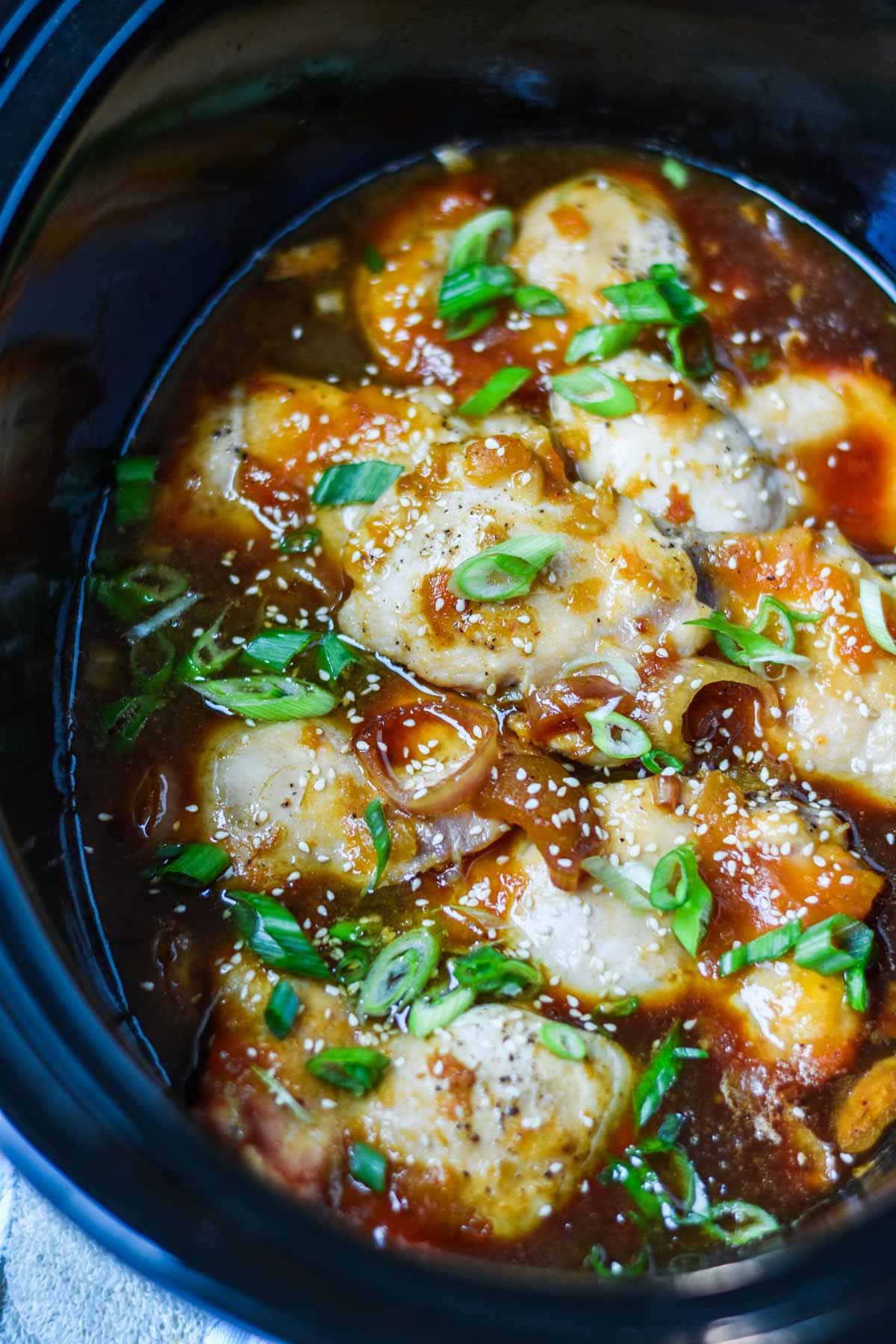 Close up image showing crockpot full of apricot chicken.